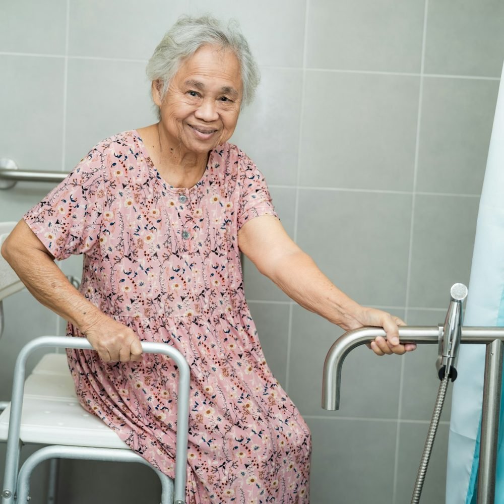 Asian senior woman patient use toilet bathroom handle security in nursing hospital